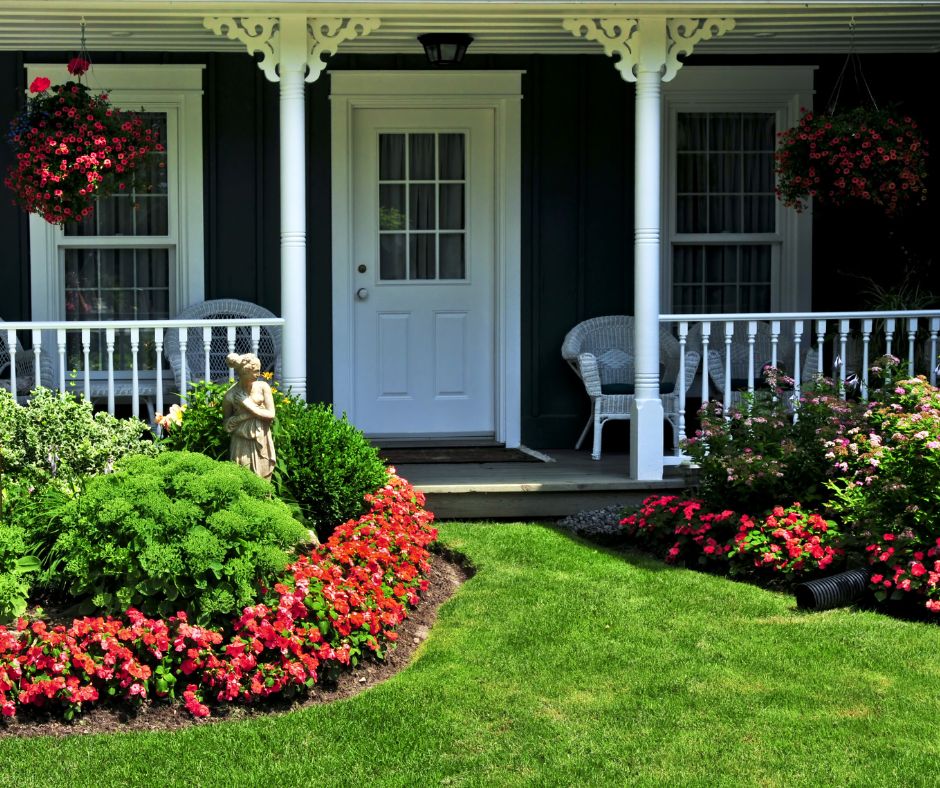 Home with spring curb appeal featuring lush lawn and flowers

