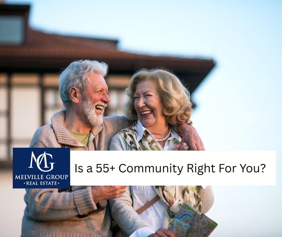 A senior couple smiling in front of a modern home in a 55+ community